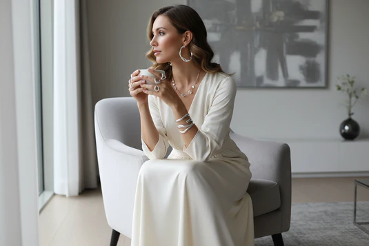 Woman wearing layered sterling silver jewelry